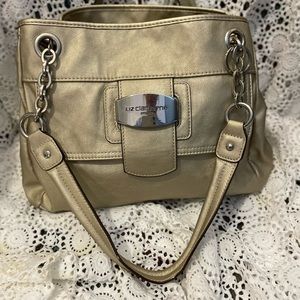 Liz Claiborne champagne, colored satchel with chains as handles. 10”L 15…
